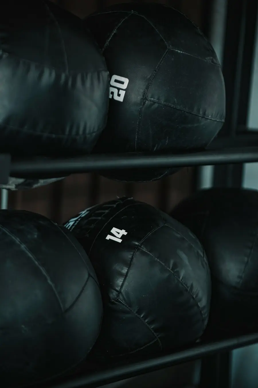 Medicine balls arranged on a gym rack